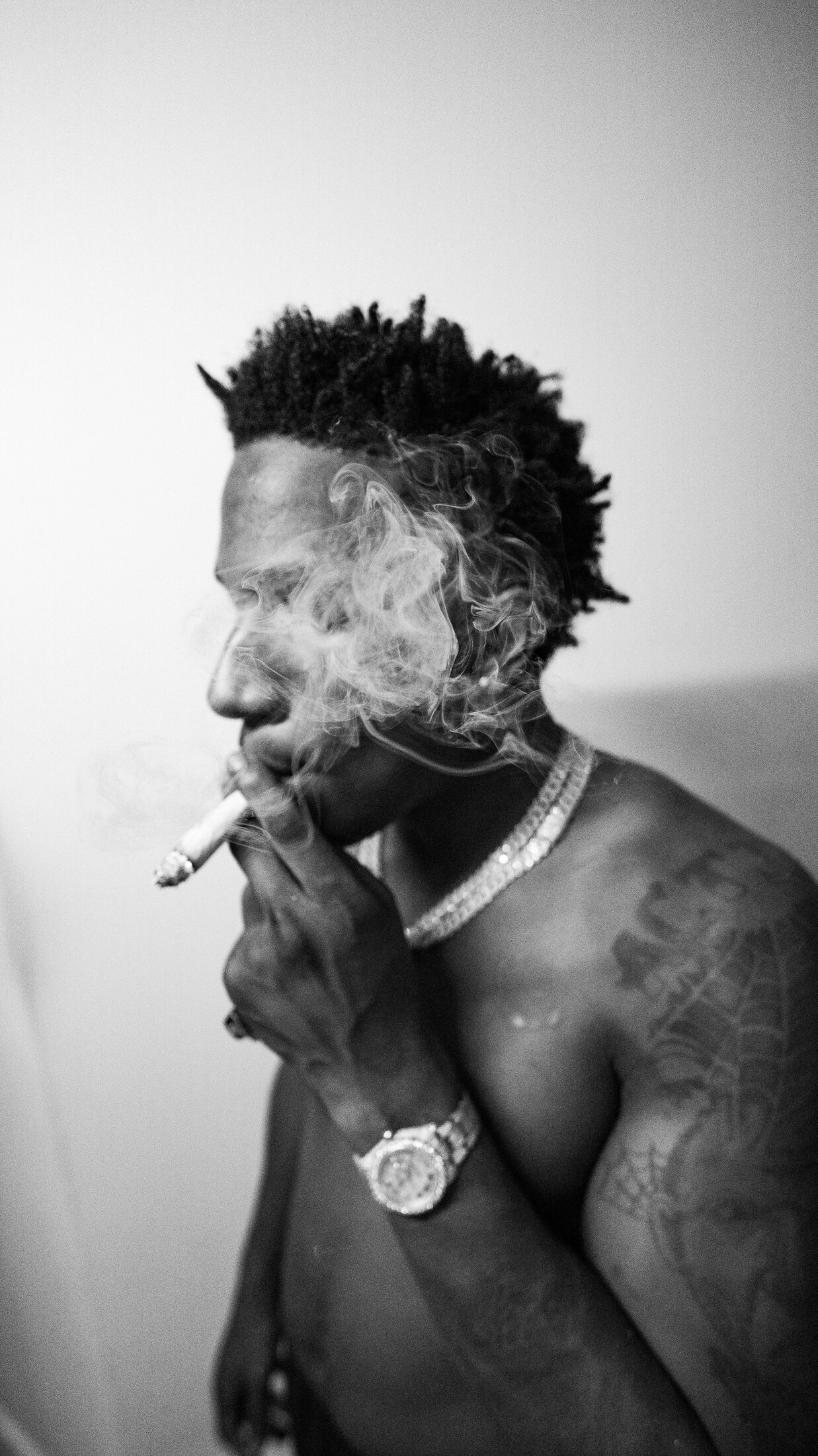 Black-and-white portrait surrounded by smoke