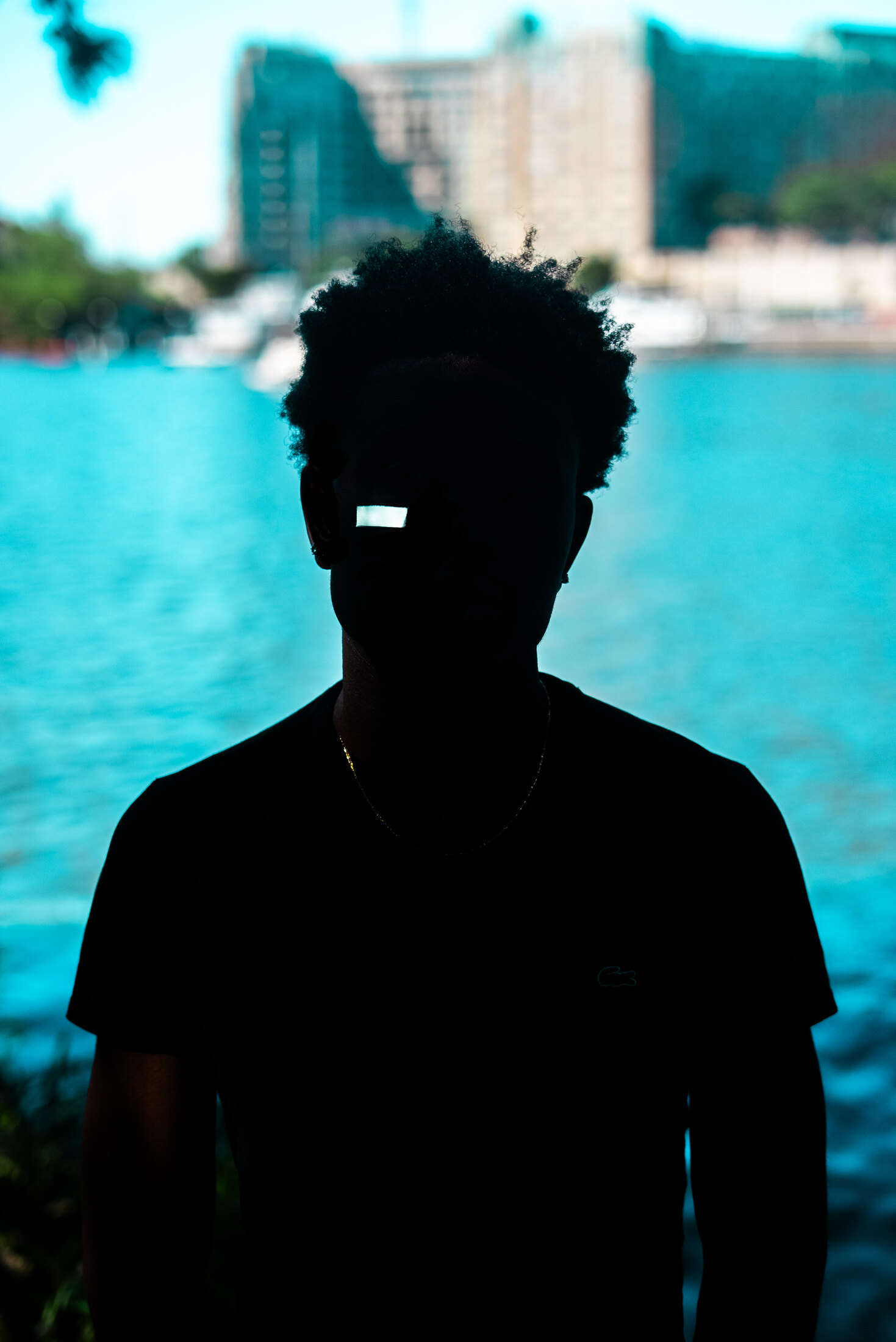 Silhouetted figure beside a swimming pool
