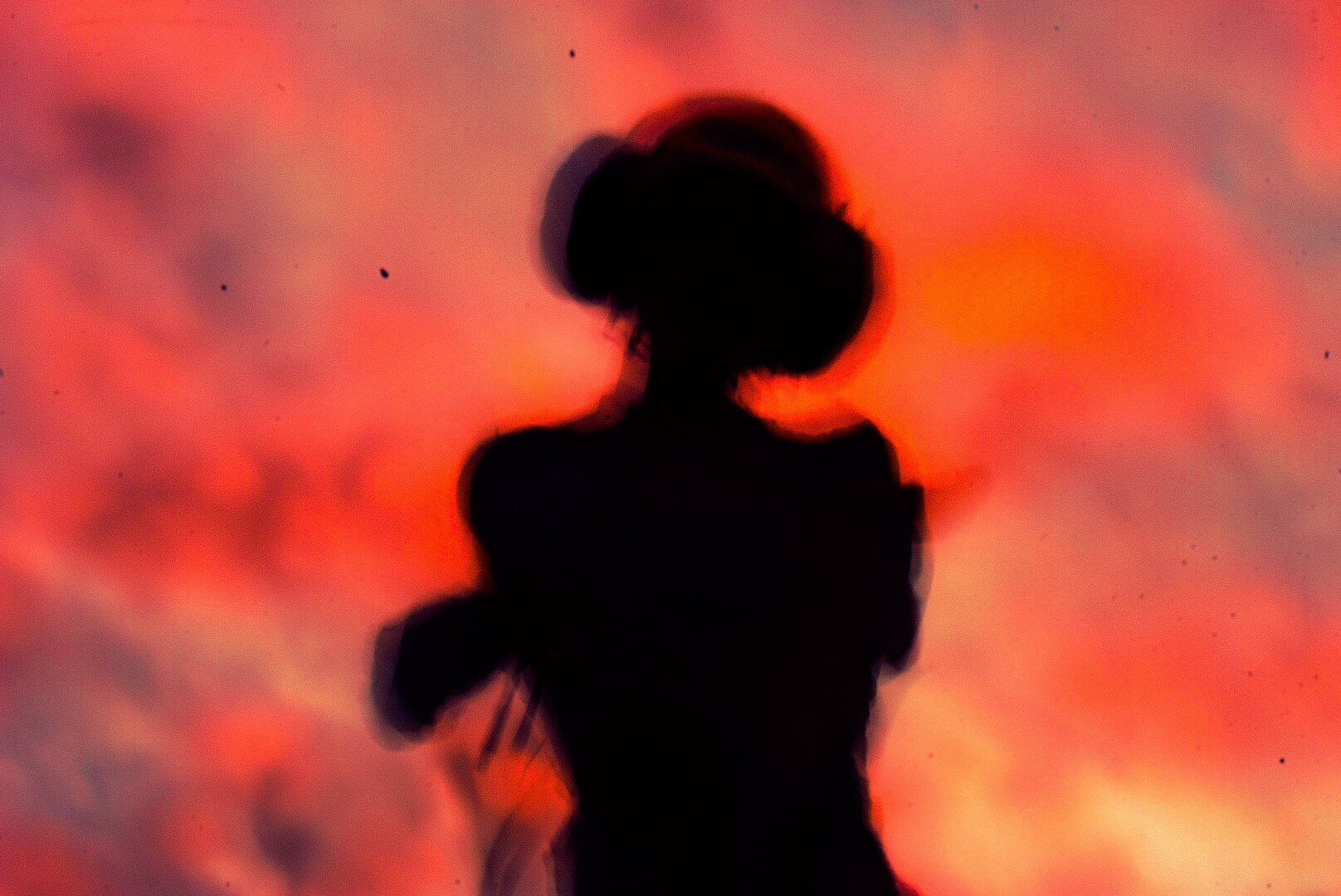 Red-lit silhouette portrait